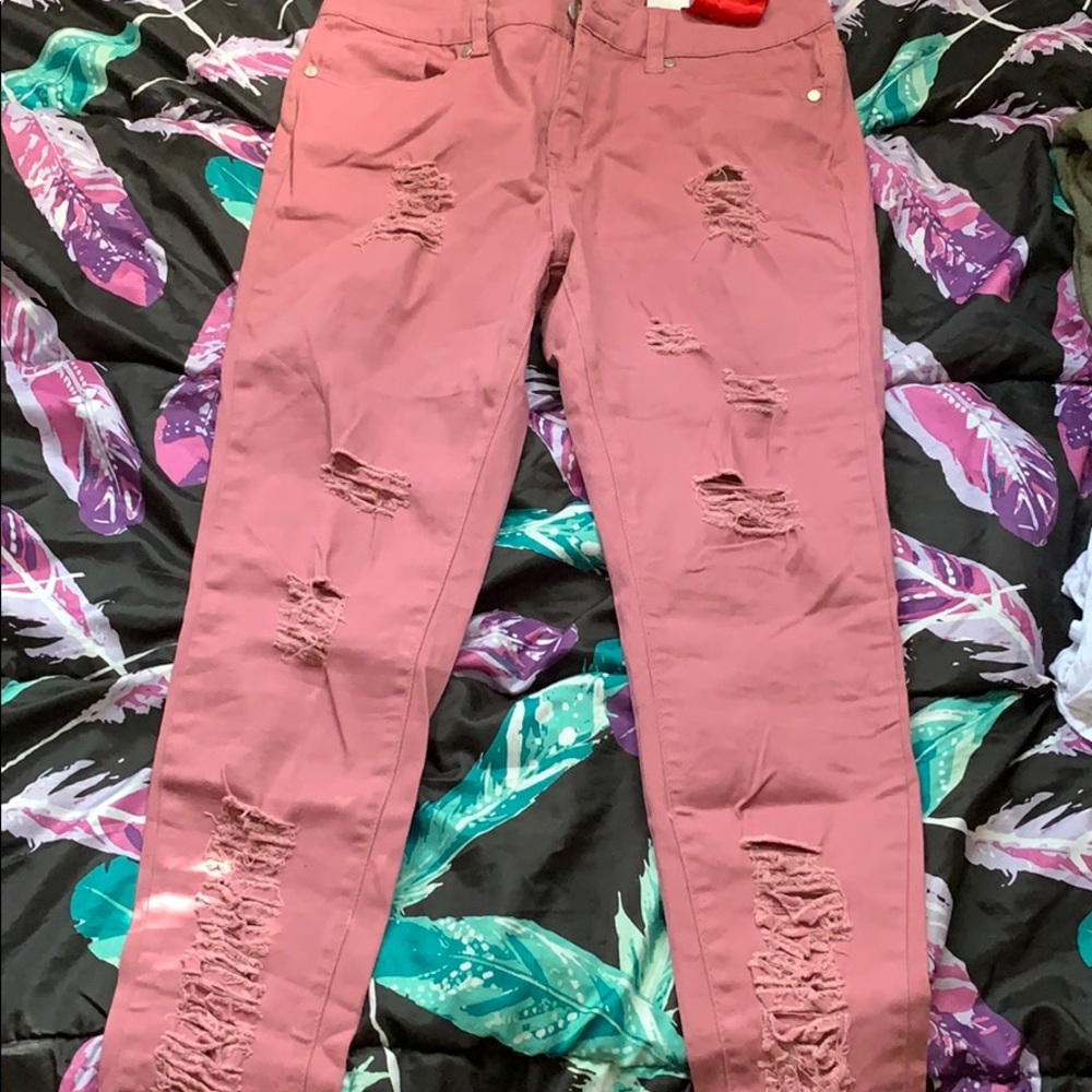 Pink distressed denim jeans